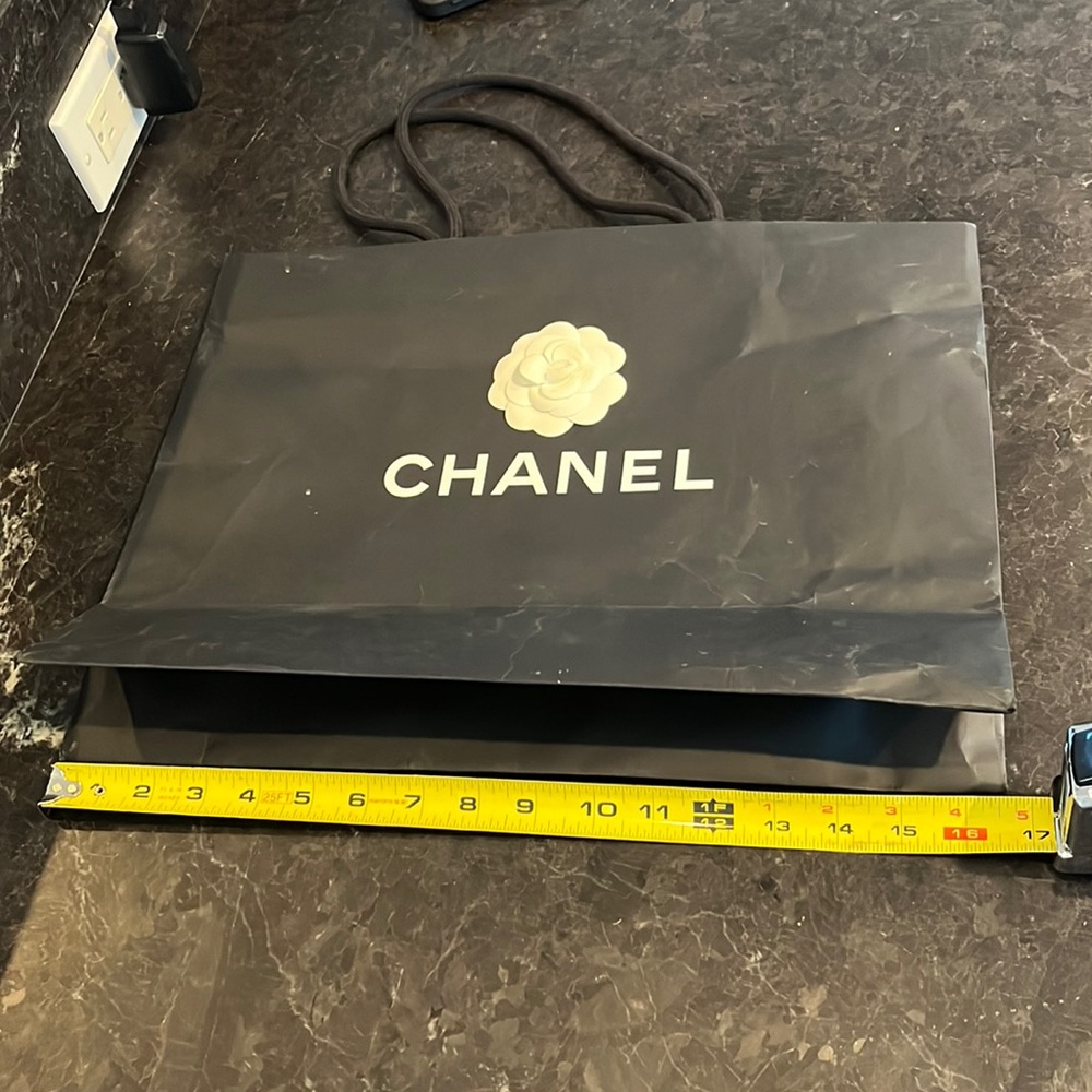 Chanel black paper shopping bag.  Slightly worn.
